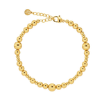 Gold beaded bracelet on a white background