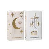 Two boxes of a tealight spinner with astrological designs on a white background